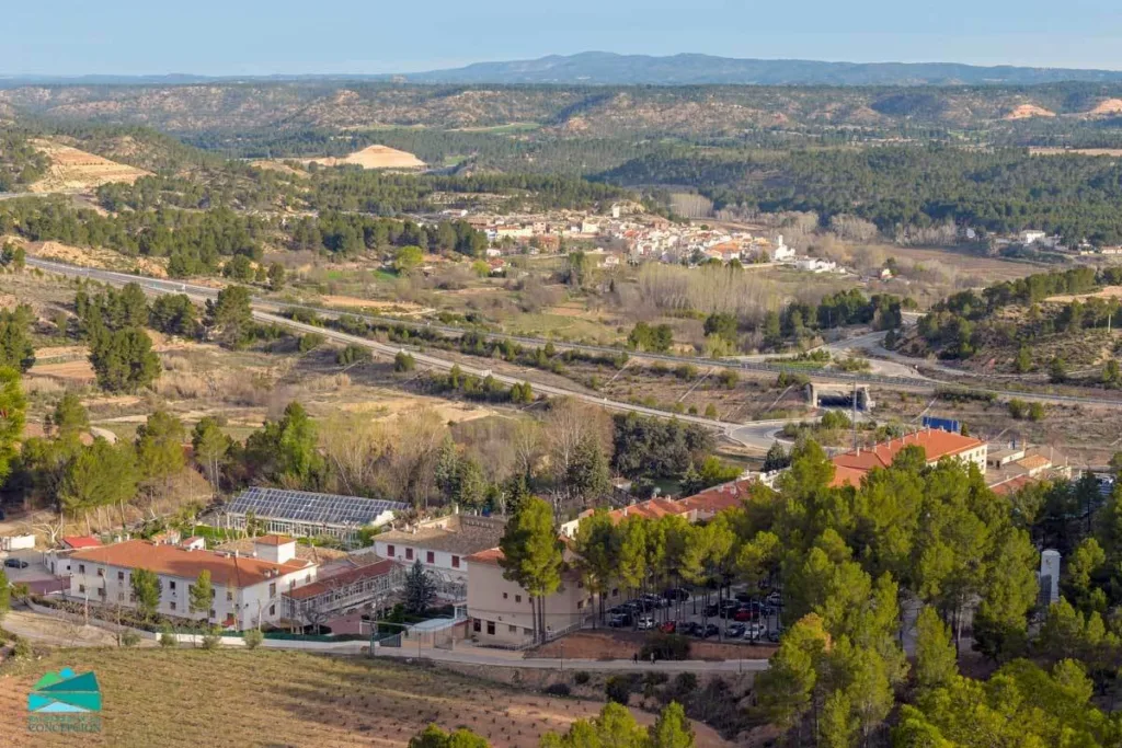 vista panorámica del balneario de la concepción rodeado de naturaleza con el pueblo de villatoya al fondo